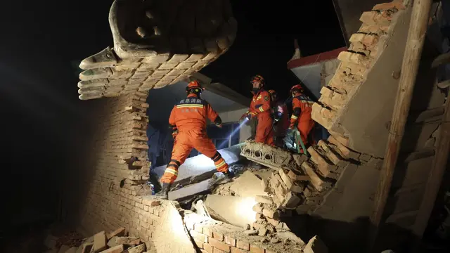 Petugas pemadam kebakaran mencari korban terdampak gempa di barat laut China. (AP)