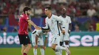 Bintang Timnas Portugal, Cristiano Ronaldo, sempat menjabat tangan pemain Georgia, Khvicha Kvaratskhelia, saat hendak meninggalkan lapangan dalam laga Grup F Euro 2024 di Arena AufSchalke, Gelsenkirchen, Kamis (27/6/2024) dini hari WIB. (AP Photo/Alessandra Tarantino)