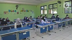 Sejumlah siswa mengikuti kegiatan belajar tatap muka di SMP Negeri 2 Bekasi, Selasa (23/3/2021). Pemerintah Kota Bekasi mengizinkan sejumlah sekolah yang berada di Zona Hijau mengadakan pembelajaran tatap muka atau PTM dengan mengikuti pedoman protocol. (Liputan6.com/Herman Zakharia)