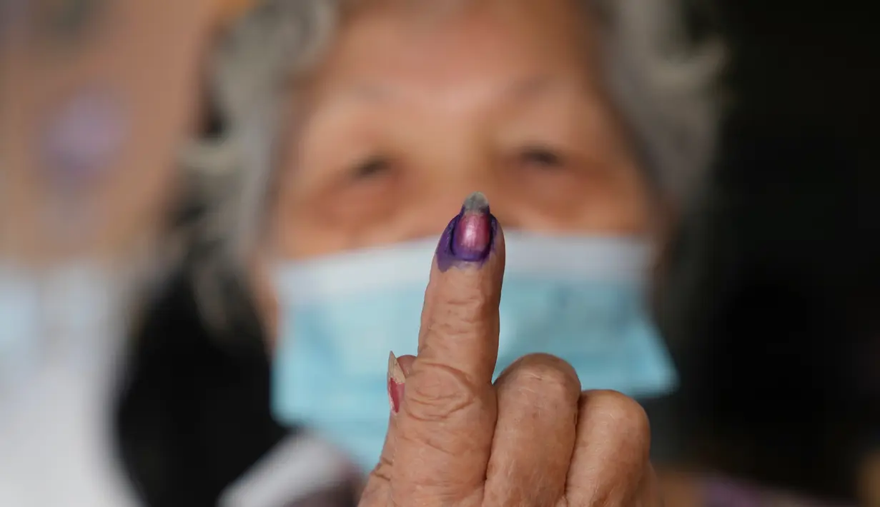 <p>Seorang perempuan menunjukkan jari yang telah dicelup tinta usai menggunakan hak pilihnya pada Pemilu Filipina di Quezon City, Senin (9/5/2022). Warga Filipina mulai memberikan suara untuk memilih presiden baru pada hari Senin, dengan putra mantan diktator yang digulingkan menjadi pesaing terkuat seorang pejuang reformasi dan hak asasi manusia. (AP Photo/Aaron Favila)</p>