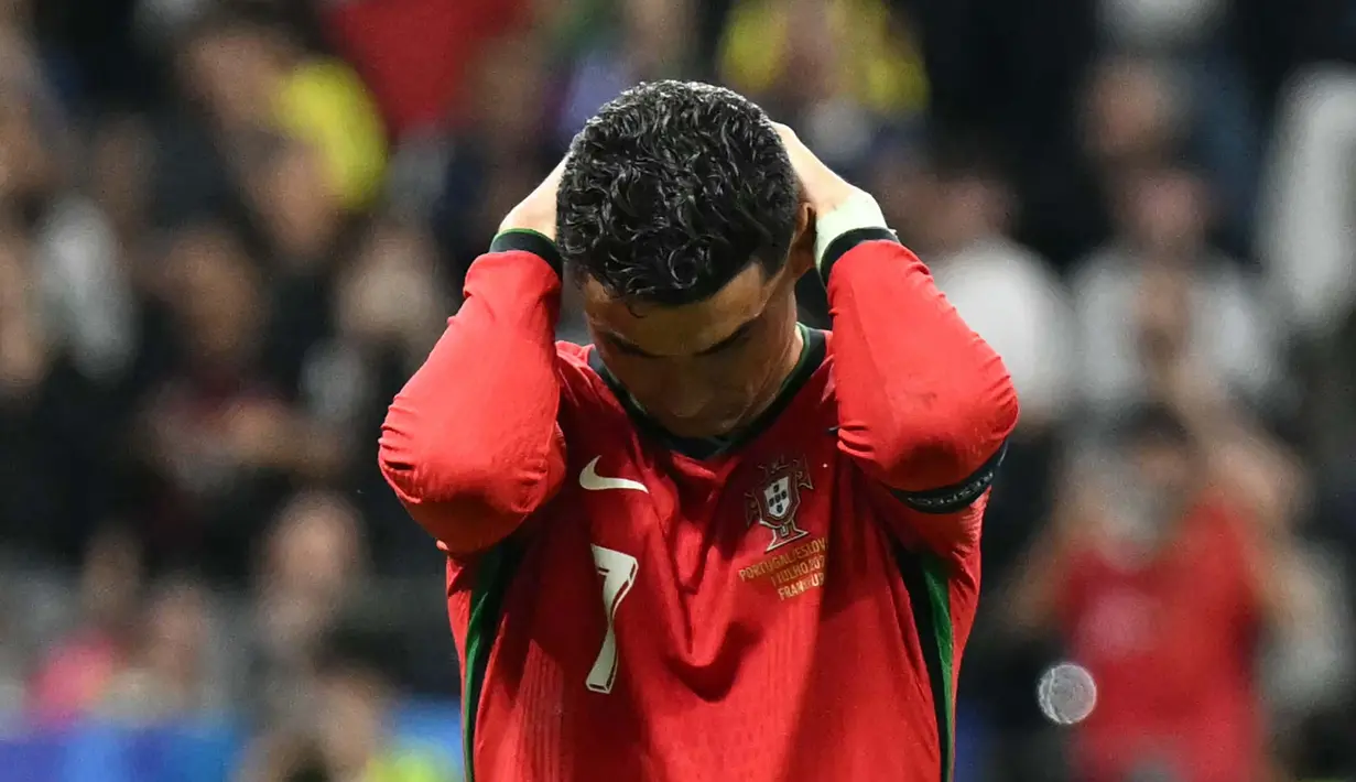 Gagal mencetak gol dari titik putih membuat Cristiano Ronaldo terlihat sangat terpukul dan sempat menangis di tengah pertandingan Portugal vs Slovenia. (PATRICIA DE MELO MOREIRA/AFP)