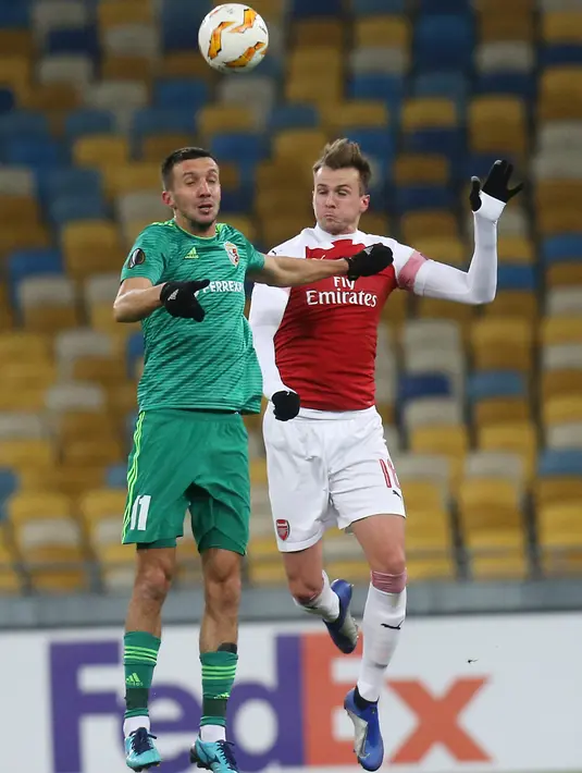 Pemain Arsenal, Nacho Monreal (kanan) berebut bola dengan Vyacheslav Sharpar asal Vorskla Poltava saat bertanding pada laga kelima Grup E Liga Europa di Stadion NSK Olimpiyskiy, Kyiv, Ukraina, Jumat (30/11). Arsenal menang 3-0. (AP Photo/Efrem Lukatsky)