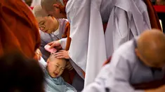 Seorang anak dicukur kepalanya oleh seorang Biksu saat upacara pemberkatan Biksu di kuil Jogye, Seoul, Senin (11/5/2015). Upacara ini diadakan bertepatan dengan hari ulang tahun Buddha. (REUTERS/Thomas Peter)