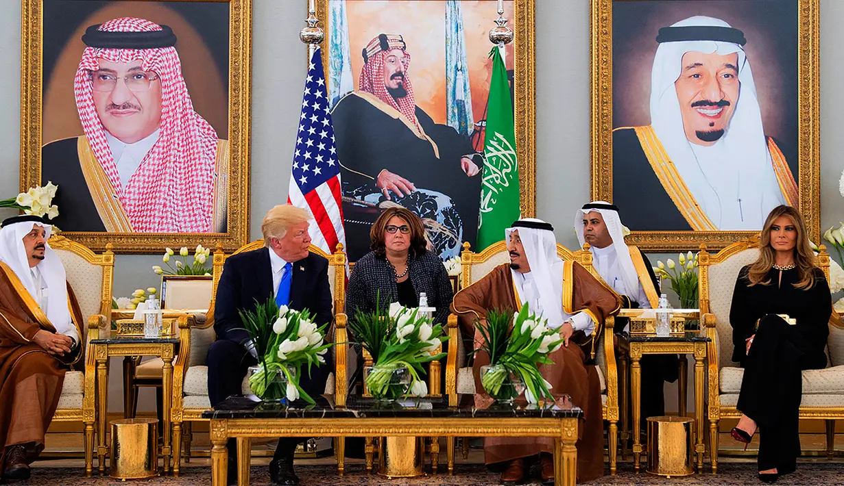 Presiden AS Donald Trump didampingi Melania Trump saat menemui Raja Arab Saudi Salman bin Abdulaziz al-Saud di Riyadh (20/5). Kunjungan ini merupakan kunjungan luar negri Trump pertama sebagai Presiden AS. (AFP/Saudi Royal Palace/Bandar Al-Jalou)