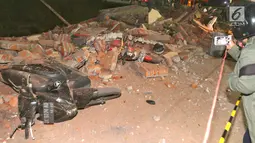Kendaraan bermotor tertimbun reruntuhan bangunan parkir bertingkat akibat gempa di Mal Galeria, Ngurah Rai, Bali, Minggu malam (5/8). Gempa di Lombok Utara yang berpotensi tsunami telah terdeteksi di Carik pada pukul 18.48 WIB. (Liputan6.com/Johan Tallo)