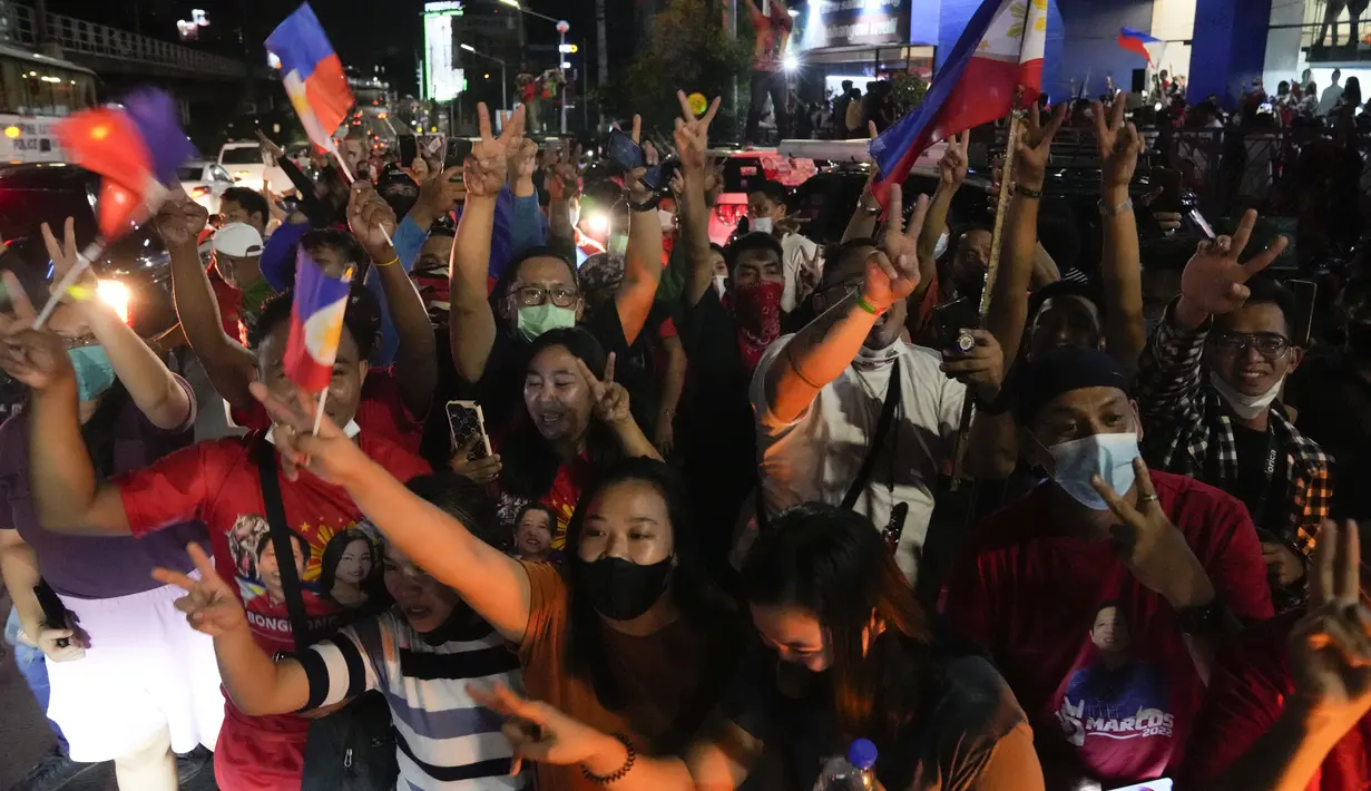 <p>Pendukung bersorak saat mereka tiba di markas Ferdinand "Bongbong" Marcos Jr di Mandaluyong, Filipina pada Senin malam (9/5/2022). Ferdinand Marcos Jr., putra mendiang Ferdinand Marcos, diktator Filipina yang terguling, jauh memimpin dalam penghitungan suara tidak resmi pemilu presiden hari Senin. (AP Photo/Aaron Favila)</p>