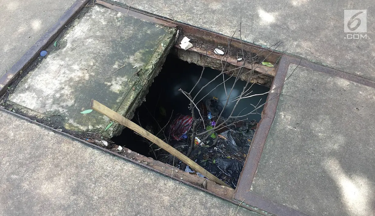 Penampakan trotoar yang rusak dan berlubang di Jalan Kyai Tapa, Jakarta, Kamis (24/1). Banyaknya lubang akibat kerusakan penutup saluran air tersebut membahayakan pejalan kaki. (Liputan6.com/Immanuel Antonius)