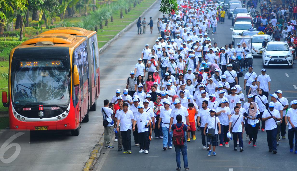 Sepanjang jalan merdeka dipadati peserta jalan sehat memperingati ke-70 Hari Bakti Postel, Jakarta, Minggu (8/11/2015). Acara ini digelar Kemkominfo untuk mengenang jasa para pahlawan telekomunikasi Indonesia. (Liputan6.com/Faisal R Syam) 