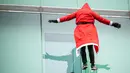 Seseorang yang menyamar sebagai Sinterklas menyapa anak-anak saat menuruni gedung klinik anak di Ljubljana, Slovenia, Rabu (22/12/2021). Beberapa Sinterklas turun dari gedung klinik pediatrik untuk menghibur anak-anak di rumah sakit dan para stafnya. (Jure Makovec / AFP)