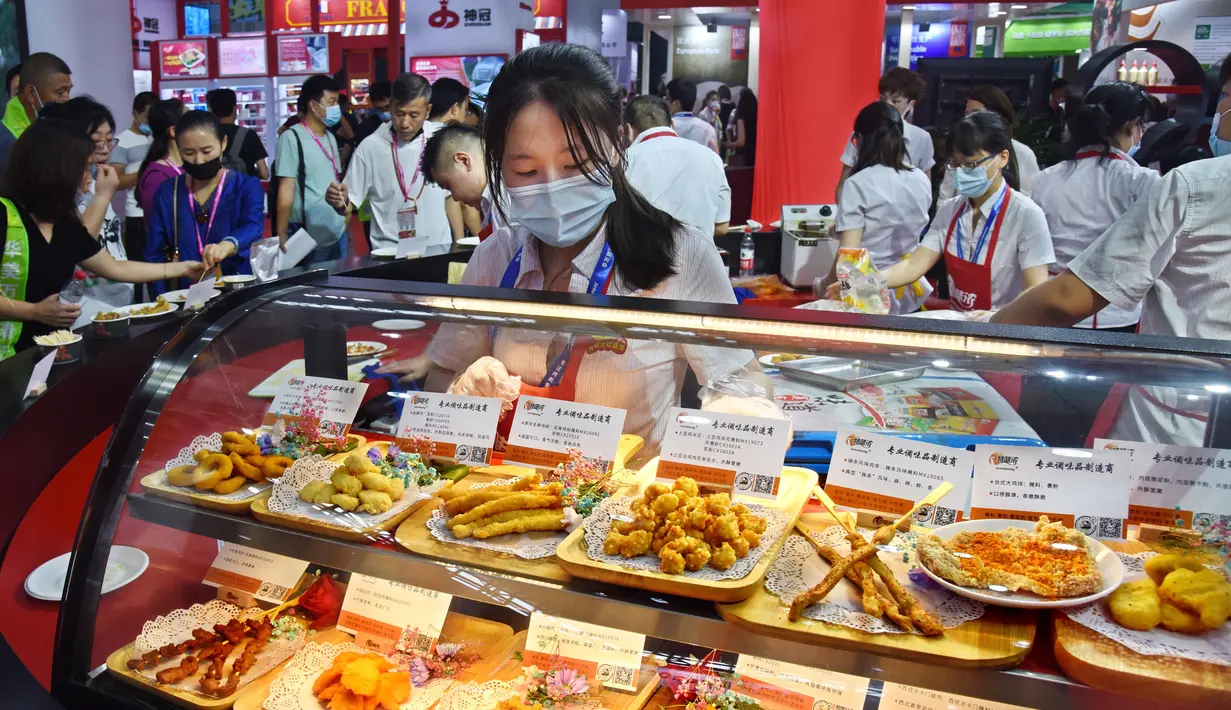 Seorang peserta pameran menyiapkan produk daging dalam Pameran Industri Daging Internasional China ke-18 di Qingdao, Provinsi Shandong, China, 10 September 2020. (Xinhua/Li Ziheng)