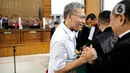 Terdakwa Agus Nurpatria berjabat tangan dengan kuasa hukum usai menjalani sidang perdana di PN Jakarta Rabu (19/10/2022). Agus Nurpatria menyalami kuasa hukum dengan penuh senyuman usai menjalani sidang dengan agenda pembacaan surat dakwaan kasus obstruction of justice atau perintangan proses penyidikan terkait perkara dugaan pembunuhan berencana terhadap Nofriansyah Yosua Hutabarat atau Brigadir J. (Liputan6.com/Faizal Fanani)