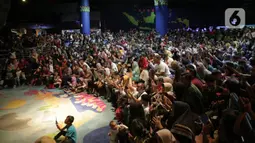 Pengunjung menyaksikan Sinterklas bersama para kurcaci menyuguhkan atraksi di Sharkquarium arena Sea World Ancol, Jakarta, Rabu  (25/12/2019). Sea World Ancol menampilkan atraksi penyelam Scuba Santa pada perayaan Natal 2019. (Liputan6.com/Faizal Fanani)