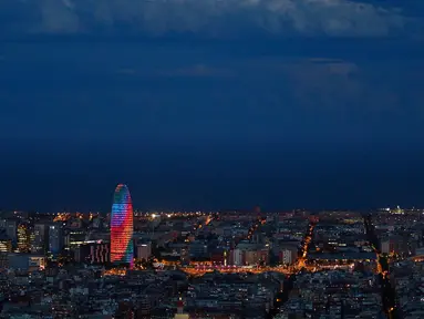 Gedung pencakar langit Torre Agbar terlihat dengan proyeksi cahaya warna pelangi saat peringatan World Pride di Barcelona, Spanyol, 28 Juni 2017. World Pride merupakan acara perayaan LGBT terbesar di dunia yang diadakan setiap tahun. (AP/Manu Fernandez)