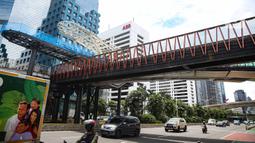 Sejumlah kendaraan melintas di bawah  revitalisasi JPO Sudirman di Jakarta, Senin (22/11/2021). Revitalisasi JPO Sudirman ditargetkan selesai pada akhir November 2021. (Liputan6.com/Faizal Fanani)
