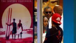 Presiden AS, Barack Obama mengantre untuk membeli es serut saat berlibur di Kailua, Hawaii, AS, (24/12). Obama dan keluarganya akan berlibur selama 17 hari hingga awal Januari 2017. (REUTERS/Kevin Lamarque)