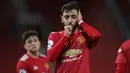 Bruno Fernandes. Gelandang Portugal berusia 27 tahun yang didatangkan Manchester United pada tengah musim 2020/2021 ini mampu menjadi top skor MU di musim 2020/2021. Ia mampu mencetak 18 gol dan 11 assist dari 37 laga di Liga Inggris di bawah Harry Kane dan Mohamed Salah. (AFP/Pool/Nick Potts)