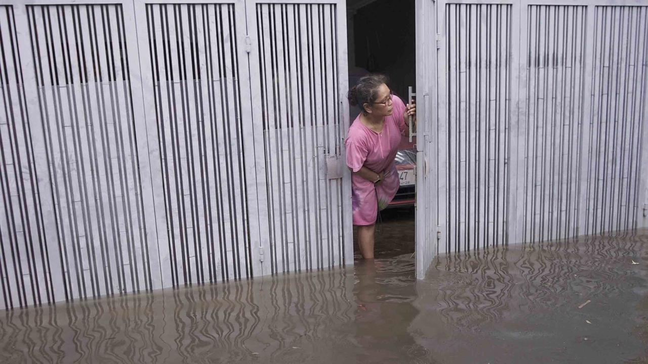 FOTO: Drainase Meluap, Warga Pasar Rebo Terobos Genangan