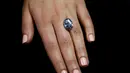Seorang petugas sedang melihat berlian biru 10,10 karat di rumah lelang sothbey, London, Inggris, Selasa (15/3). Berlian berbentuk oval ini akan dilelang di Magnificent Jewels dan Jadeite Hongkong pada 5 April 2016. (REUTERS / Stefan Wermuth)