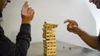 Pelanggan tunarungu bermain game di bar kopi "Sin Palabras" di Bogota (19/7).  Kafe ini merupakan kafe pertama di kota tersebut yang melayani para pengunjung tunarungu. (AFP Photo/Raul Arboleda)