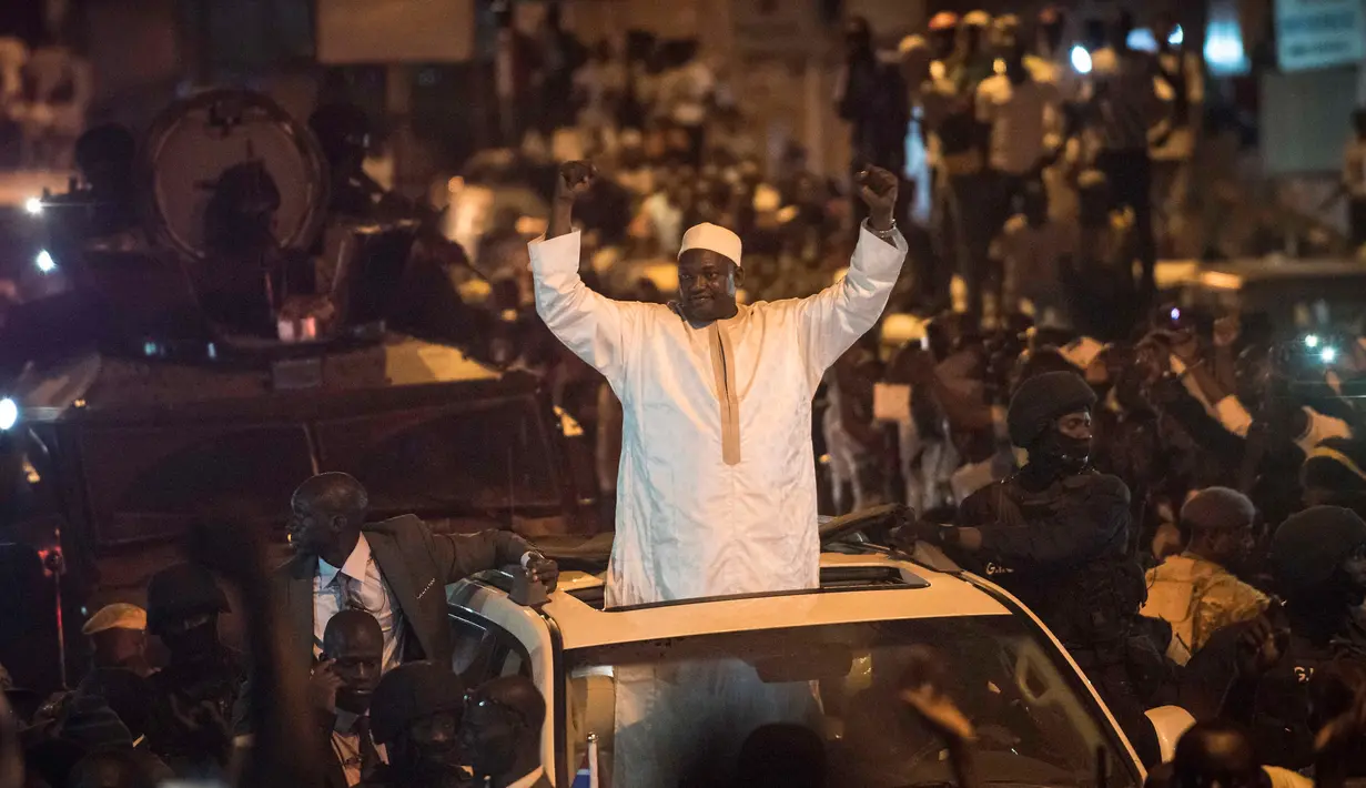 Presiden baru Gambia, Adama Barrow, mengepalkan kedua tangan setelah kembali ke negaranya, Kamis (26/1) malam. Barrow, yang memenangkan pemilihan umum presiden pada Desember, tinggal sementara di Senegal atas alasan keamanan. (AP Photo/Sylvain Cherkaoui)