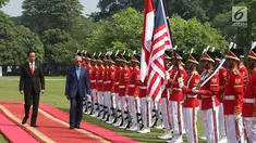 Presiden Jokowi dan PM Malaysia, Mahathir Mohamad memeriksa pasukan kehormatan saat kunjungan kenegaraan di Istana Bogor, Jumat (29/6). Kedua pemimpin akan menggelar pertemuan bilateral membahas berbagai isu dan kerjasama. (Liputan6.com/Angga Yuniar)