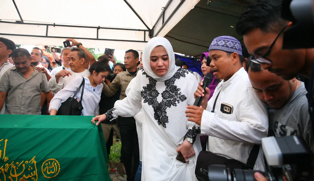Setelah selesai memberikan sambutan, lantunan ayat suci mengiringi jenazah yang mulai diurung dengan tanah. Proses pemakaman berjalan dengan lancar meski diselimuti suasana haru dan isak tangis bagi keluarga yang di tinggalkan. (Nurwahyunan/Bintang.com)