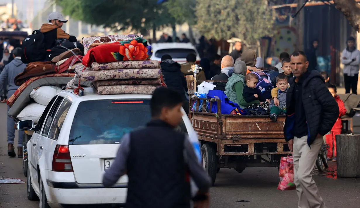 Warga Palestina mengendarai kendaraan saat mereka bergerak menuju daerah yang lebih aman setelah dimulainya kembali serangan Israel di Rafah di Jalur Gaza selatan pada 1 Desember 2023. (MAHMUD HAMS/AFP)