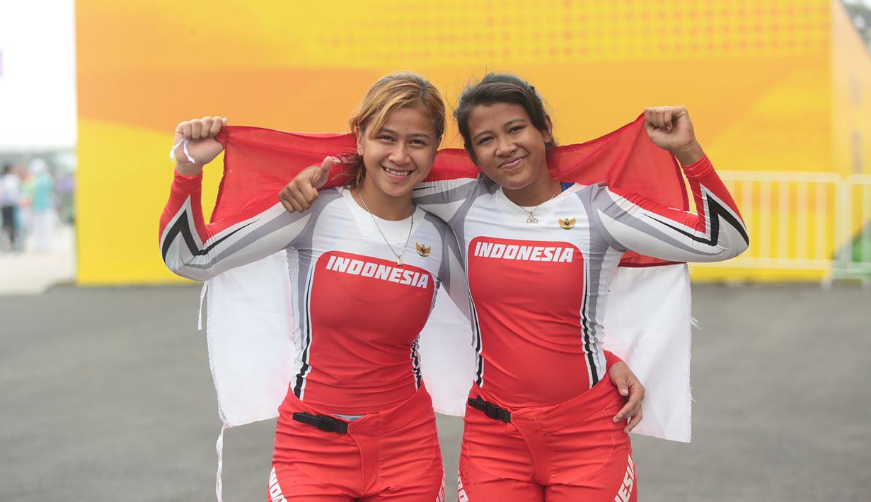 Selebrasi dua pembalap BMX putri Indonesia, Amellya Nur Sifa (kanan) yang merebut medali emas dan Jasmine Azzahra Setyobudi yang menyumbang medali perunggu setelah berakhirnya lomba balap sepeda nomor BMX putri Asian Games 2022 di Chun'an Jieshou Sports Centre BMX Course, Minggu (1/10/2023) pagi WIB. (PB ISSI/Nick Hanoatubun)