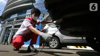Teknisi melakukan uji emisi pada uji emisi gratis Asuransi Astra, di Jakarta, Minggu (12/12/2021). Sebanyak 400 mobil berusia diatas 3 tahun dari berbagai merk ikuti uji emisi untuk mengetahui kinerja mesin dan tingkat efisiensi pembakaran dalam mesin kendaraan bermotor. (Liputan6.com/Fery Pradolo)