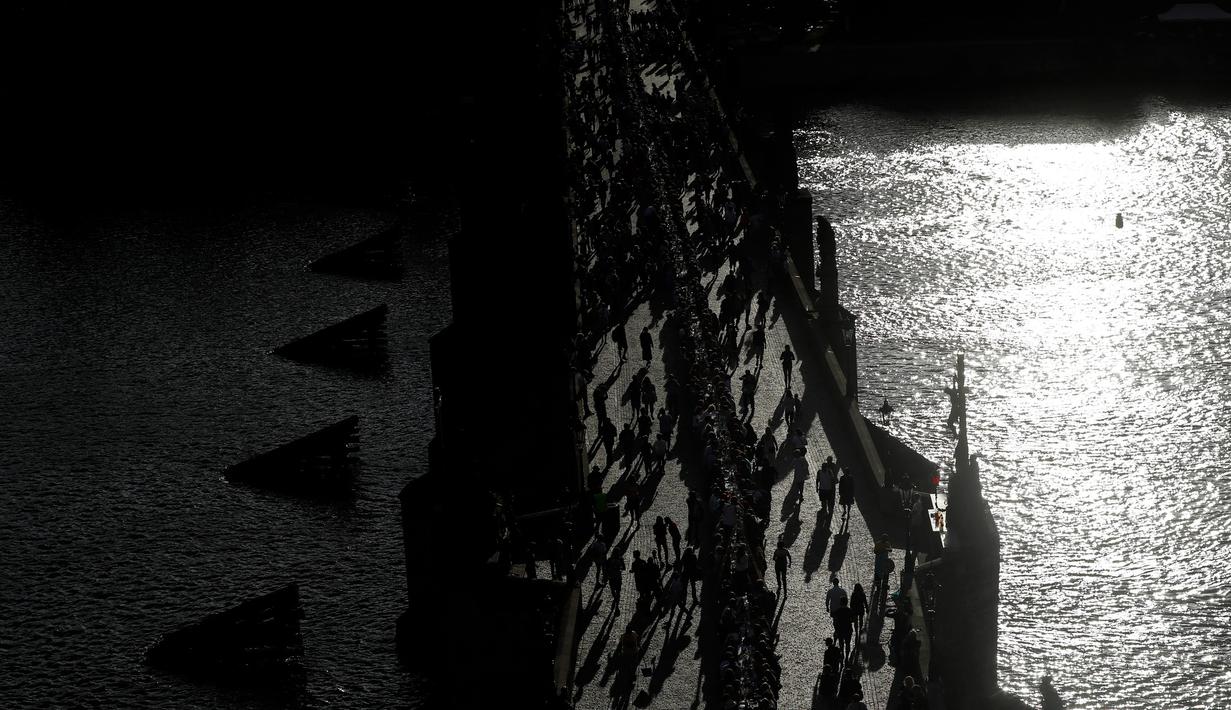 Warga Ibu Kota Republik Ceko, Praha, berkumpul di Jembatan Charles merayakan berakhirnya krisis virus Corona di negara itu dengan menggelar makan malam bersama di atas meja sepanjang 500 meter. (AP Photo/Petr David Josek)