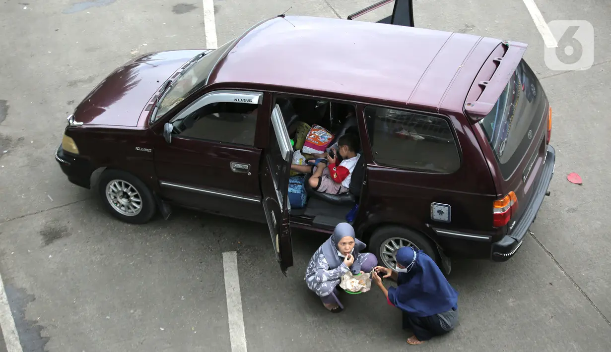 <p>Pemudik keluar dari kendaraannya untuk makan sambil beristirahat saat berada di Pelabuhan Merak, Banten, Jumat (29/4/2022). Banyak pemudik yang memanfaatkan waktu sebelum masuk kapal dengan beristirahat di area dermaga setelah mereka terjebak macet hingga berjam-jam. (Liputan6.com/Angga Yuniar)</p>