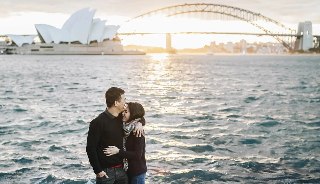 Berlatar belakang Opera House Sydney, saat matahari terbenam, pelukan hangat Joe kepada Julia terlihat mesra, seperti menggambarkan cinta yang tak akan pudar. (Liputan6.com/IG/julietaslim)