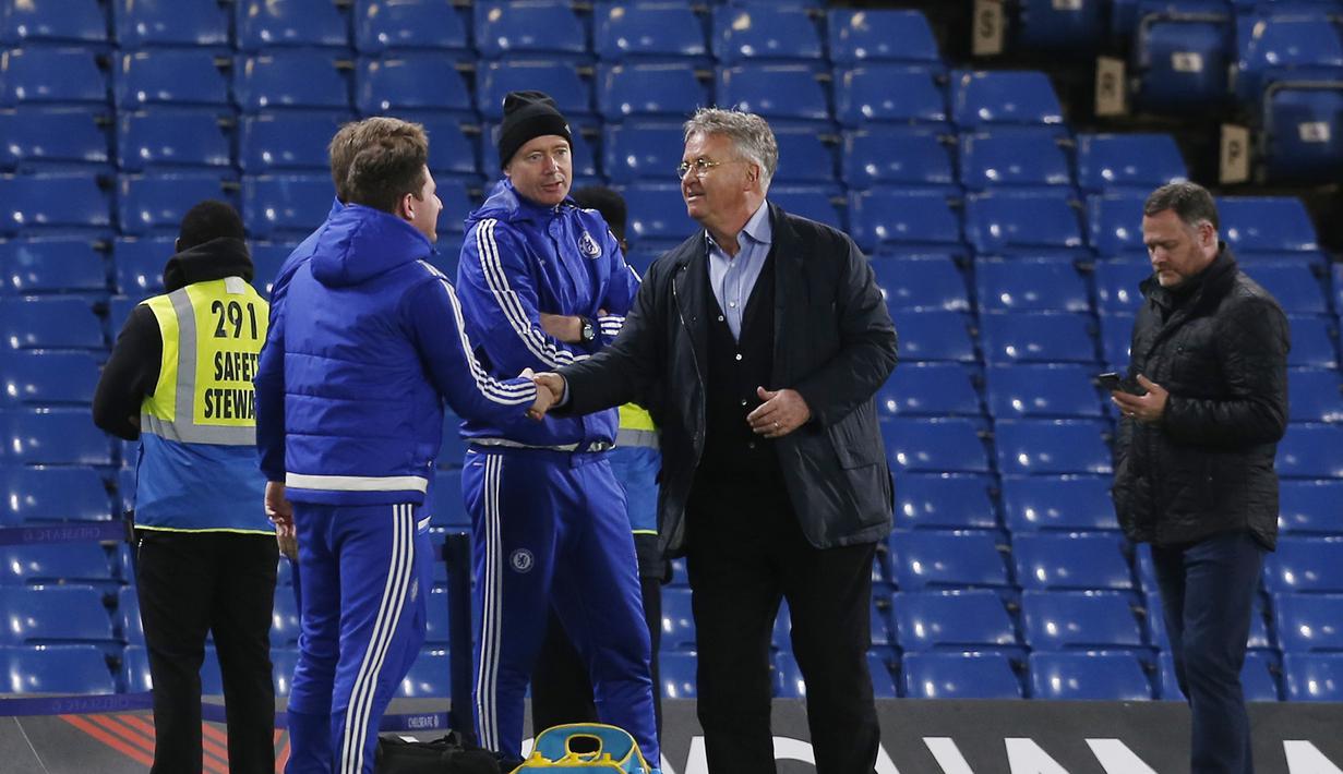 Pelatih Chelsea,  Guus Hiddink (kanan) bersalaman dengan staff operasional Chelsea usai menang lawan Sunderland di Stadion Stamford Bridge, London, Sabtu (19/12/2015).  (AFP Photo/Ian Kington)