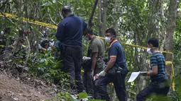 Tim forensik Malaysia menggali sebuah makam tak bertanda di Wang Burma, dekat perbatasan Malaysia-Thailand, (26 /5/2015). Penemuan lokasi kuburan massal diduga sebagai migran dari Myanmar dan Bangladesh. (AFP PHOTO/MOHD RASFAN)