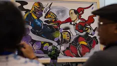 Pengunjung melihat  gambar komik yang menunjukkan Presiden Indonesia Joko Widodo, sebagai karakter Avenger versus Thanos di Festival Pop Culture Popcon Asia 2018 di BSD, Tangerang Selatan, Sabtu (22/9). (AFP PHOTO / BAY ISMOYO)