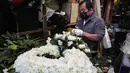 Pedagang membuat karangan bunga sebelum Hari Valentine di tengah pandemi COVID-19 di distrik di Los Angeles, California (12/2/2021). Toko bunga di daerah tersebut sibuk tahun ini dengan pemesanan bunga Hari Valentine dan karangan bunga pemakaman COVID-19. (Mario Tama/Getty Images/AFP)