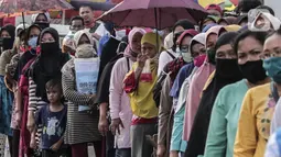 Warga antre untuk menerima Bantuan Sosial Tunai (BST) di Desa Cikande, Kecamatan Jayanti, Kabupaten Tangerang, Banten, Selasa (23/6/2020). Bantuan tersebut merupakan salah satu program jaring pengaman sosial terkait pandemi virus corona COVID-19. (Liputan6.com/Johan Tallo)