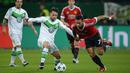 Pemain Wolfsburg, Christian Traesch (tengah) berebut bola dengan pemain Manchester United, Memphis Depay  pada lanjutan liga Champions di Stadion VfL Wolfsburg Arena, Rabu (9/12/2015) dini hari WIB. (AFP Photo/Julian Stratenschulte)