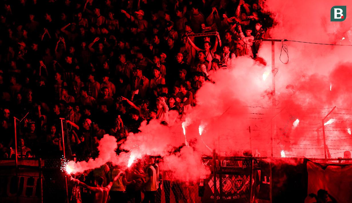 <p>Flare menyala di antara para pendukung Semen Padang saat laga leg kedua final Pegadaian Liga 2 2023/2024 antara Semen Padang mengadapi PSBS Biak di Stadion GOR Haji Agus Salim, Padang, Sabtu (9/3/2024). (Bola.com/Bagaskara Lazuardi)</p>