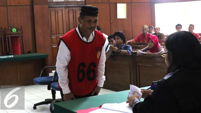 Daeng Aziz memberikan surat berisi nama-nama yang ingin dihadirkan oleh JPU, Pengadilan Negeri Jakarta Utara, Rabu (18/5). Daeng Azis menjadi terdakwa pada kasus pencurian listrik di Kali Jodoh (Liputan6.com/Herman Zakharia)