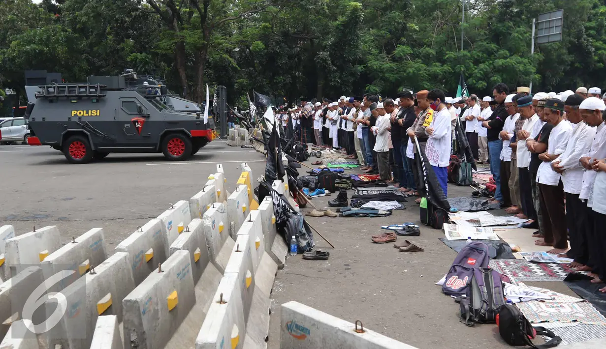 Peserta Aksi Damai 4 November melaksanakan Salat Jumat di Jalan Merdeka Barat, Jakarta, Jumat (4/11). Aksi Damai ini menuntut Pemerintah untuk segera mengadili Ahok karena dinilai telah menistakan agama. (Liputan6.com/Faizal Fanani)