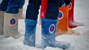 Para pemain mengenakan sepatu tradisional Rusia, Valenki, saat pertandingan persahabatan antara wartawan dan mahasiswa asing di lapangan bersalju di Nizhny Novgorod, Rusia, Minggu (21/1). (AFP PHOTO/Mladen ANTONOV)