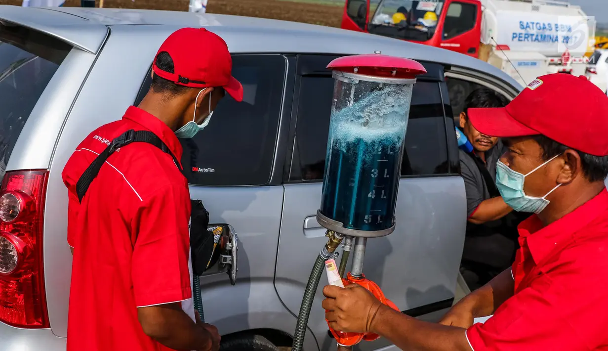 Petugas mengisi bahan bakar minyak (BBM) kendaraan di kios Pertamina tol fungsional (tol darurat) Brebes Timur-Gringsing, Tegal, Jawa Tengah, Jumat (30/6). PT Pertamina menjamin ketersedian BBM untuk arus balik aman. (Liputan6.com/Faizal Fanani)