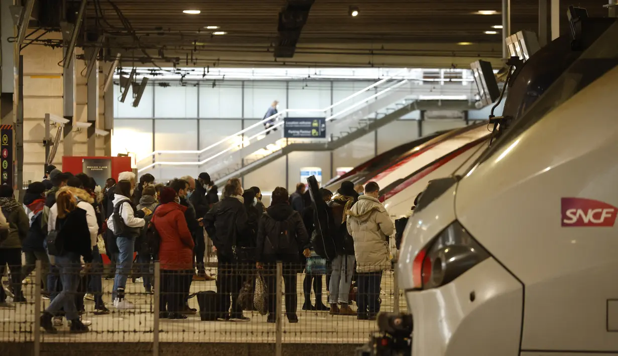 Warga Paris menunggu untuk menaiki kereta yang berangkat dari Gare Montparnasse, di Paris, Jumat (19/3/2021). Warga Paris memadati kereta antar kota yang berangkat dari ibu kota beberapa jam sebelum aturan lockdown selama sebulan untuk memerangi lonjakan infeksi COVID-19. (Ludovic MARIN/AFP)