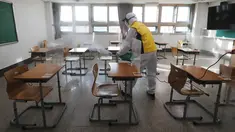 Petugas kesehatan mendisinfeksi ruang kelas untuk ujian masuk perguruan tinggi di Seoul, Korea Selatan, Selasa (1/12/2020). Sekitar 490.000 siswa lulusan sekolah menengah atas di Korea Selatan akan menjalani Tes Kemampuan Skolastik Perguruan Tinggi pada 3 Desember 2020. (AP Photo/Ahn Young-joon)