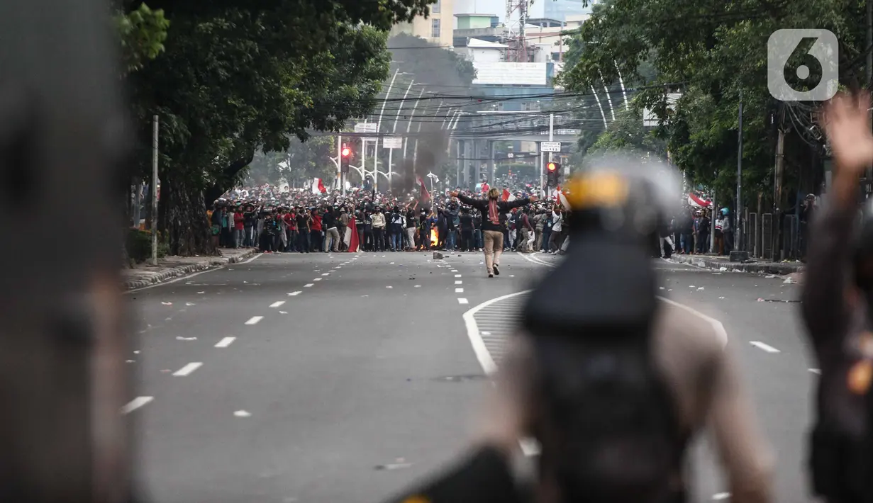 Anggota brimob memukul mundur massa aksi di kawasan Tanah Abang, Jakarta, Selasa (13/10/2020). Hingga menjelang magribh massa masih melakukan perlawan di kawasaan tersebut. (Liputan6.com/Faizal Fanani)