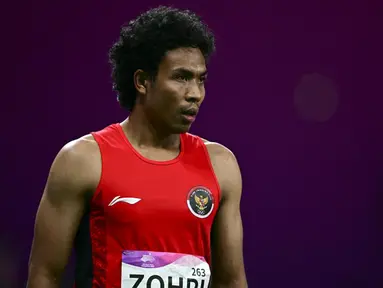 Pelari asal Indonesia, Lalu Muhammad Zohri bereaksi usai berlaga pada final 100m putra Asian Games 2023 di Hangzhou, Provinsi Zhejiang, China, Sabtu (30/9/2023). (Manan VATSYAYANA/AFP)