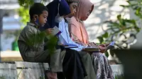 Orang-orang berdoa saat memperingati 17 tahun musibah gempa dan tsunami di Taman Peringatan Tsunami Siron di Siron, provinsi Aceh (26/12/2021). Tsunami Aceh pada 2004 merenggut nyawa lebih dari 170.000 orang di Indonesia saja. (AFP/Chaideer Mahyuddin)