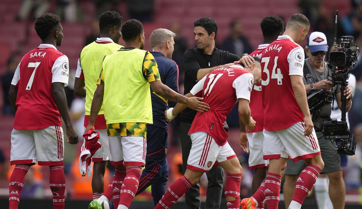 Hingga laga usai Arsenal mampu mempertahankan keunggulan 3-1 atas Totenham Hotspur. Dengan tambahan tiga poin, Arsenal semakin kokoh di puncak klasemen dengan raihan 21 poin. Sementara Tottenham Hotspur harus menderita kekalahan pertamanya musim ini dan sementara menempati posisi ketiga dengan 17 poin dan gagal menggeser posisi Manchester City dari peringkat kedua. (AP/Kirsty Wigglesworth)