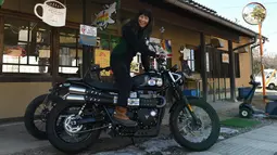 Reiko Miyoshi (60) berpose dengan motor Triumph Street Scrambler miliknya di luar "Perefa Cafe" di Matsumoto, prefektur Nagano (23/2). Miyoshi memulai petualangan pertamanya sepanjang 30.000 kilometer. (AFP Photo/Toshifumi Kitamura)